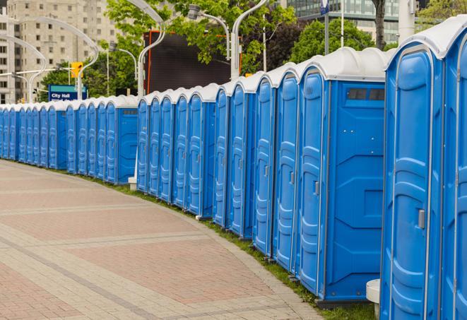 hygienic portable restrooms lined up at a music festival, providing comfort and convenience for attendees in Atlanta